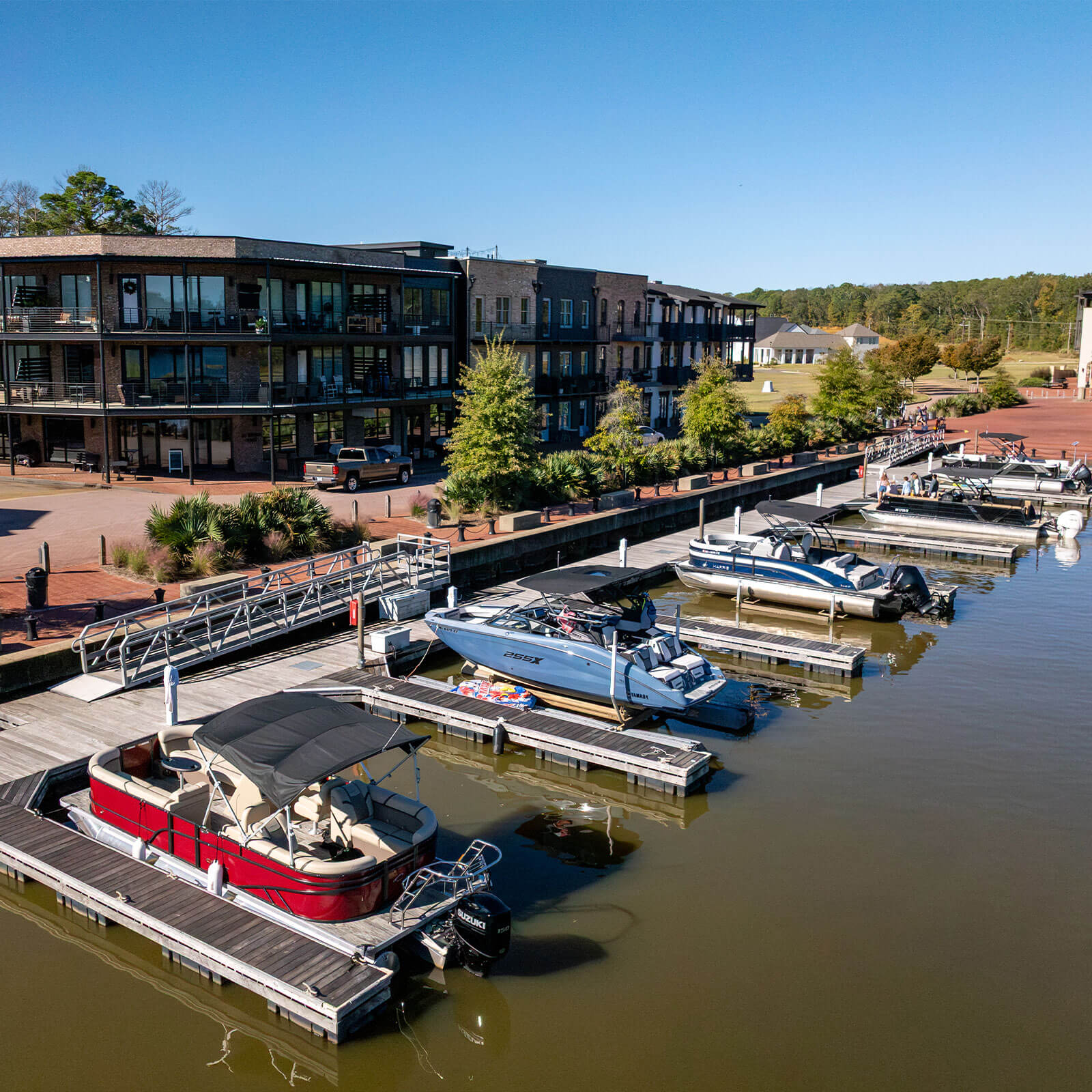 A line of moored boats in The Town of Lost Rabbit's private marina on Ross Barnett Reservoir.
