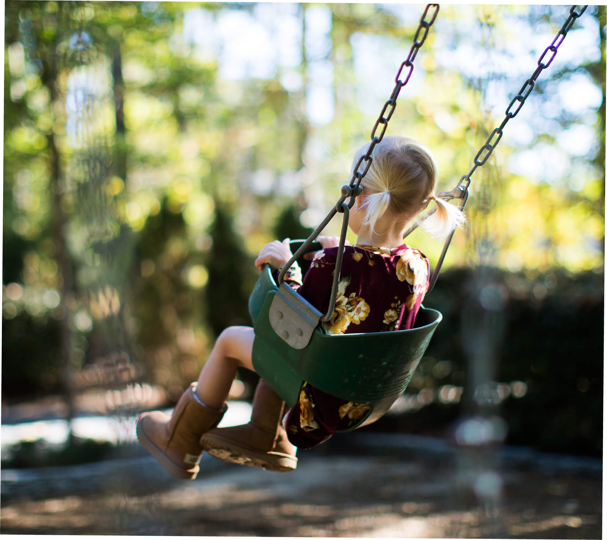child swinging in a swingset